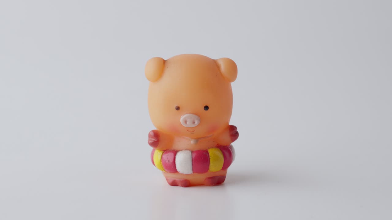 Hand Picking Up Cute Miniature Pig Toy