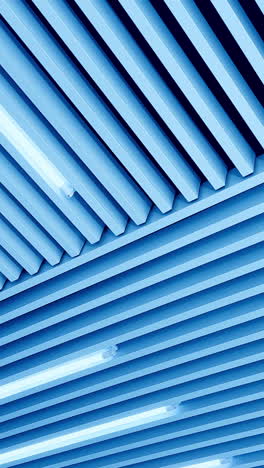 bright illumination on the embossed plank ceiling. white light led lamps switched on. low angle view. vertical video