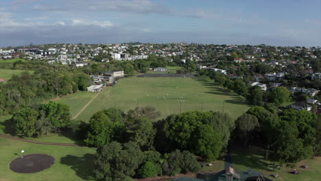 flight towards cricket pitch where cricketers play final match, aerial shot