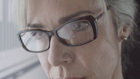 closeup of focused female business professional in glasses