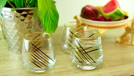 an elegant glass of water is carefully placed on a table