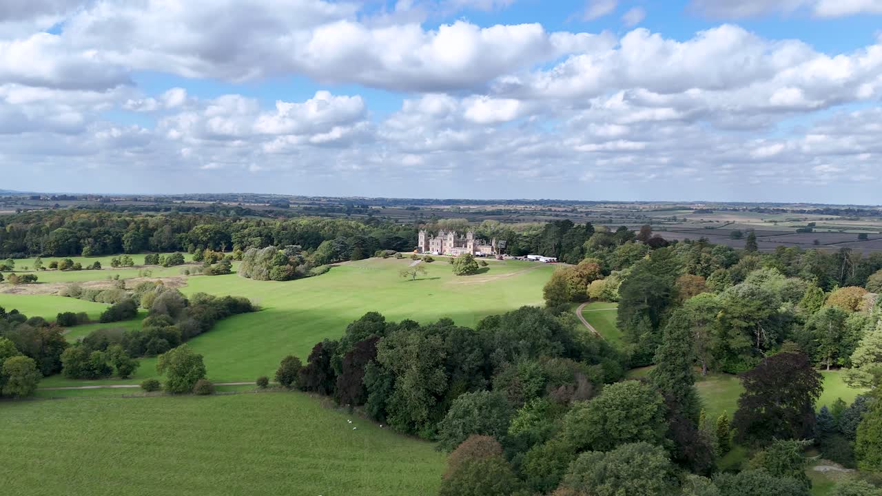Mentmore Towers, Buckinghamshire, England - A Scenic View of a Mansion Nestled Amid Lush Greenery - Pan Up Shot