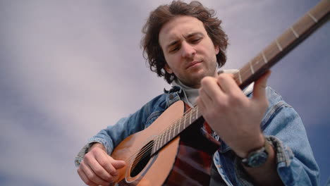 a young boy plays the guitar