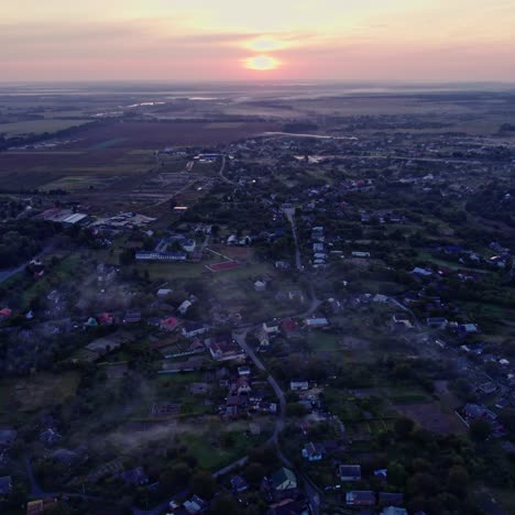 sunrise over a misty village