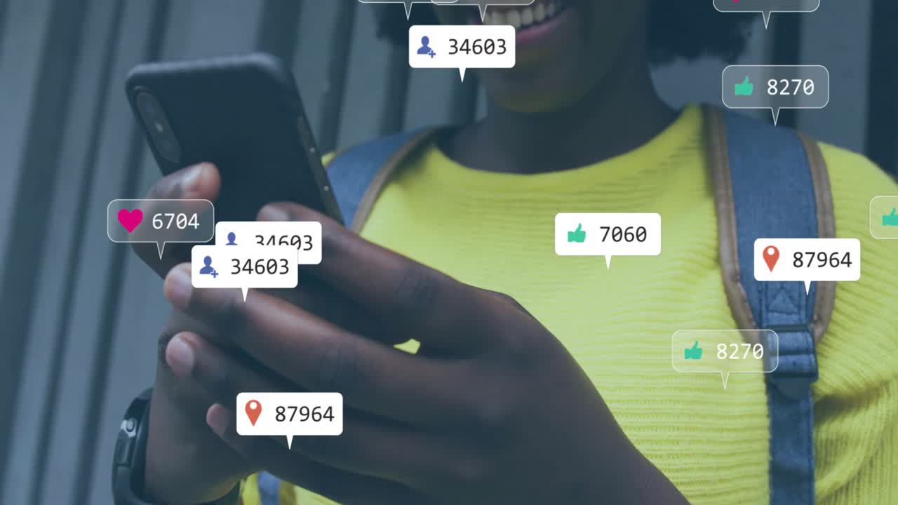Animation of social media notifications over happy african american woman using smartphone in city