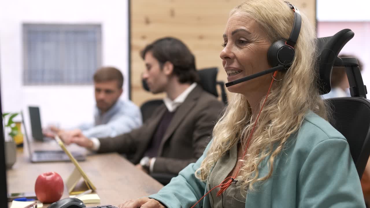 Female executive in headset working in office