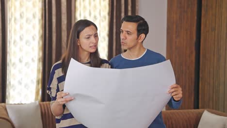 indian couple discussing house plan