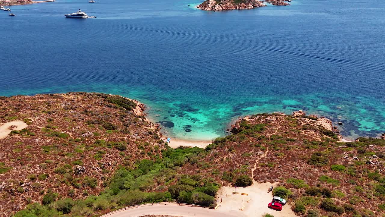 Aerial view of a secluded Sardinia beach with clear blue water and green hills