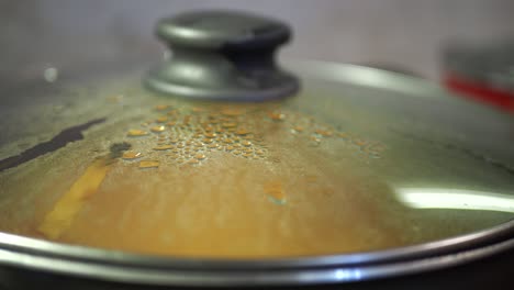 close-up of a covered pot with condensation