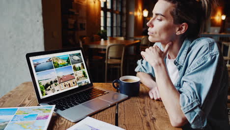 woman working in a cafe with city view and maps