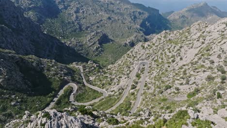 winding u turn and snaking bend in road nestled in deep valley, sa calobra road in serra de tramuntana mallorca
