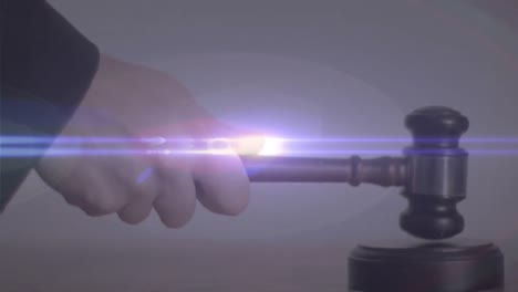 Animation-of-man-hitting-with-hammer-at-auction-with-purple-light-trail-moving-in-the-foreground