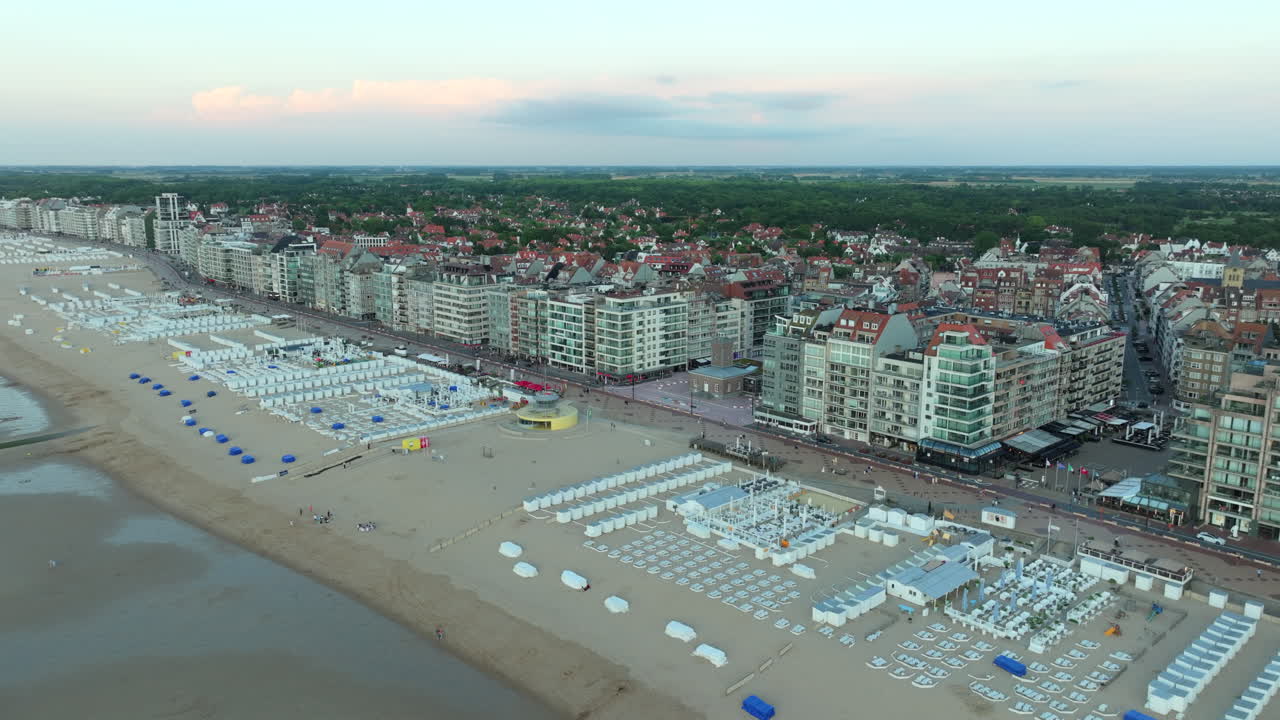 Knokke Beach with Bars and Seaside Apartment Buildings Aerial Dolly In