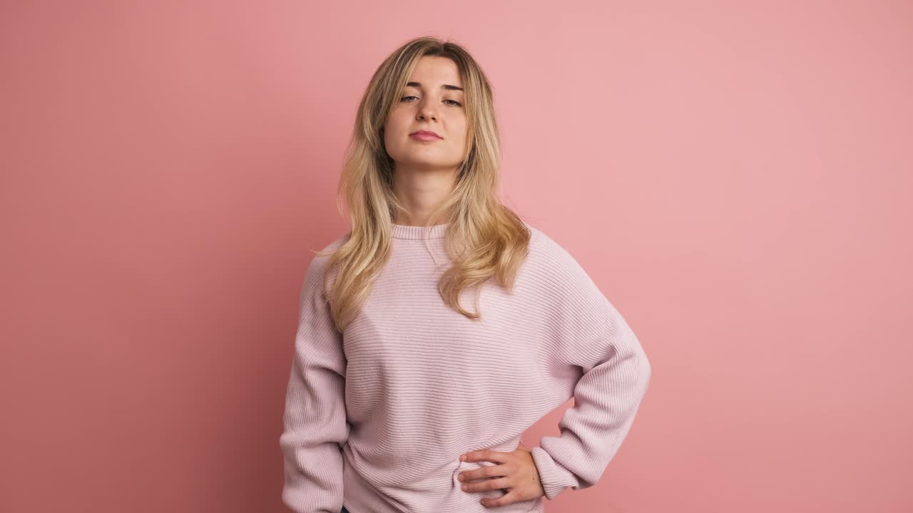 Confident woman gesturing disagreement with thumb down