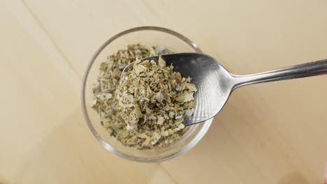 mediterranean dried oregano herbs in a tablespoon