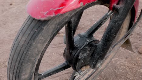 close up shot of the front wheel with the drum brake of a bajaj motorcycle imported to africa