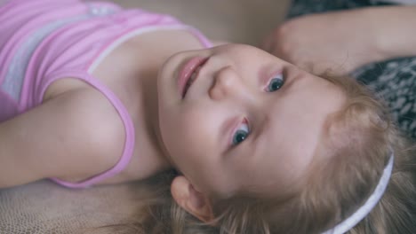 mother cures girl eyes with clear drops in light room