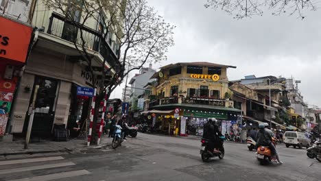 motorbikes and trucks at a bustling intersection