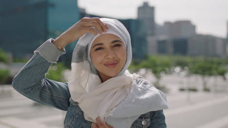 portrait of beautiful young muslim woman student removing traditional hajib headscarf smiling happy at camera