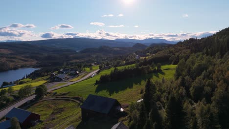 aerial view of a picturesque countryside featuring rolling hills, lush green forests, and a clear sky