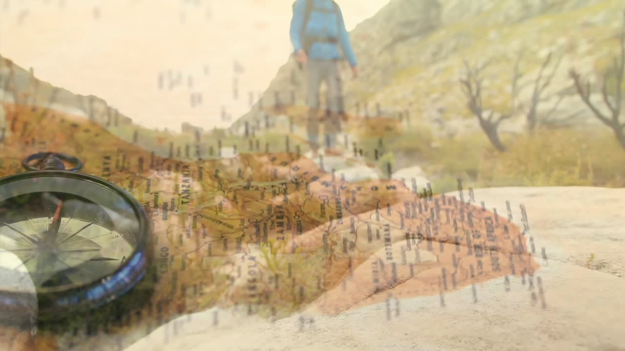 Male hiker walking rocky mountain slope, showing metallic compass lying on travel map overlay