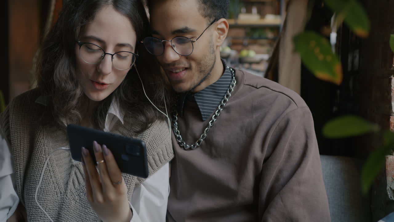 Couple enjoying a video call in a cafe