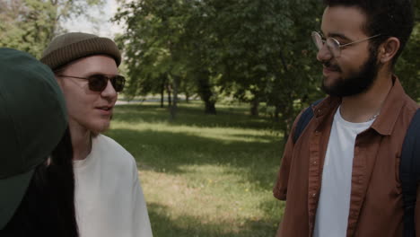 young adults engaging in conversation in a park