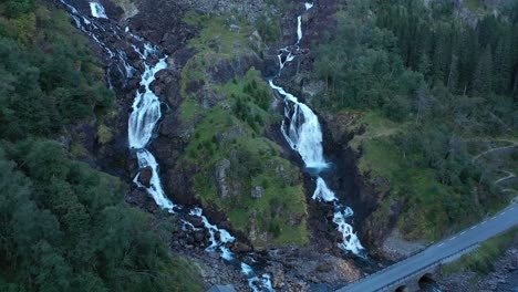 låtefoss - late evening aerial during dusk - backward moving aerial from closeup to overview of famous tourist attraction norway