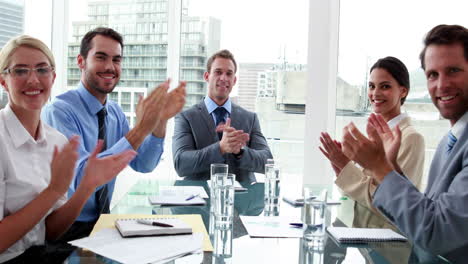 Business-people-clapping-at-camera-in-board-room