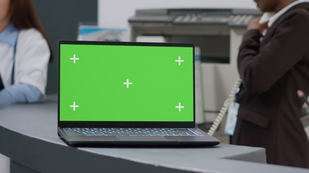 Laptop with green screen in a medical reception area