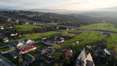 aerial footage of long highway bridge in stunning mountains scenery at sunset