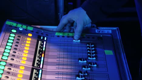 sound engineer adjusting mixing console