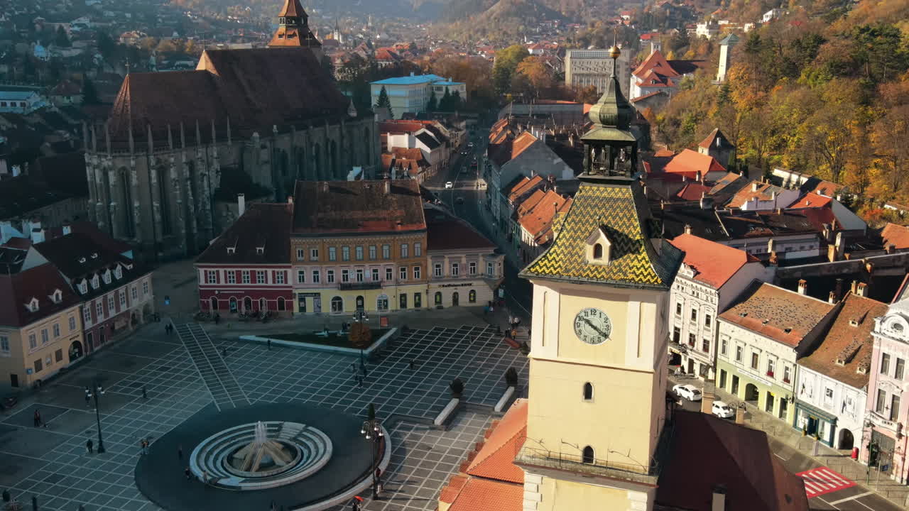 Aerial drone view of The Council Square in Brasov, Romania. Old city centre with The Black Church and County Museum of History, buildings, people