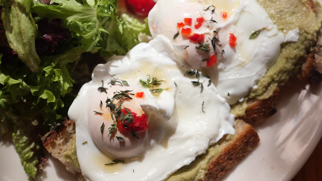 Poached eggs with avocado toast and salad