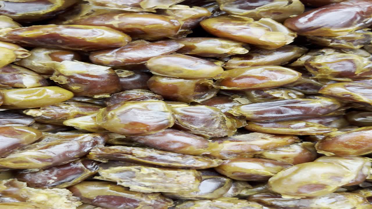 Close-up Vertical Shot of Many Brown Dried Dates
