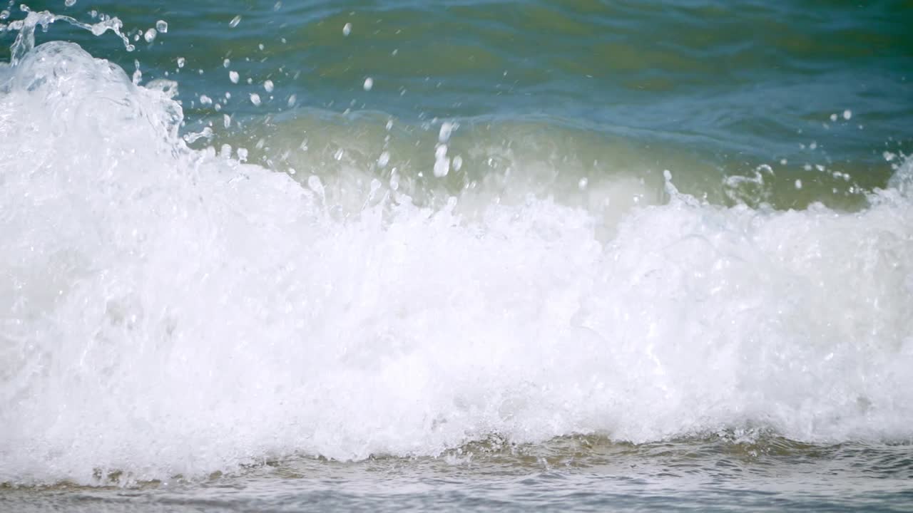 Swells of foamy waves, surging and splashing by the seaside of Pattaya Beach in Chonburi province in Thailand
