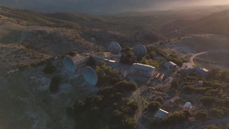 satellite dishes on mountaintop at sunset