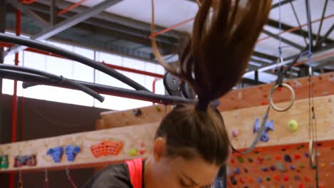 hermosa mujer caucásica decidida haciendo sentadillas de salto en el gimnasio 4k