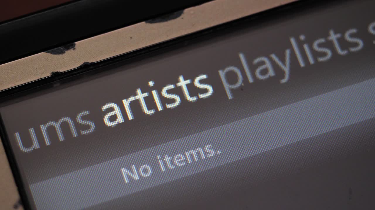 Macro shot of vintage mp3 player browsing music library categories