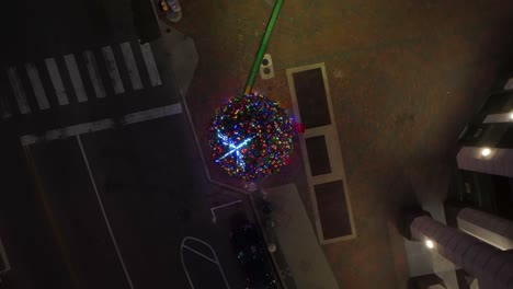 top down aerial of lit christmas tree at night