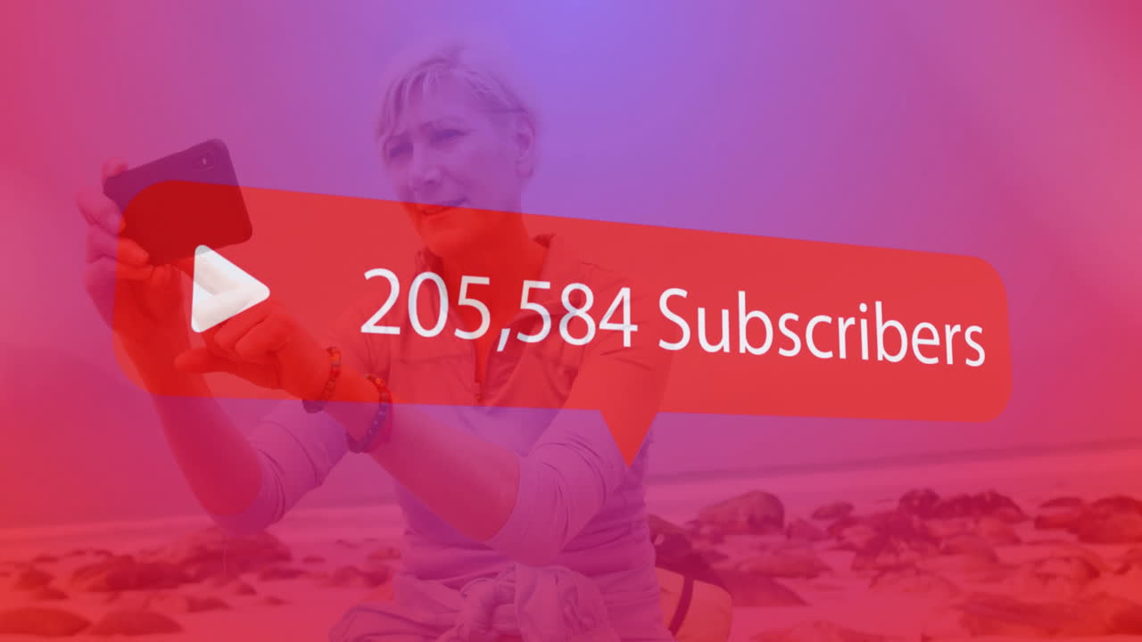 Play button and subscriber count animation over person taking selfie on beach