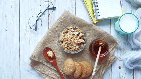 healthy breakfast with granola, milk, honey and cookies