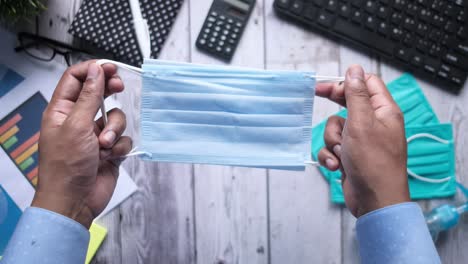 person holding face masks at workplace