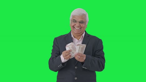 Happy-Indian-senior-manager-counting-money-Green-screen