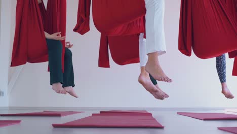 women legs with bare feet hanging down from hammocks