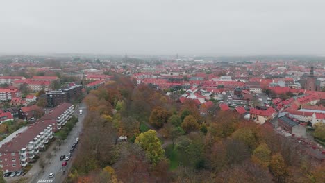 aerial tilting up view of a graveyard in the small town ystad, in österlen, south sweden, cloudy, autumn