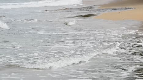 Nahaufnahme-Von-Kleinen-Wellen,-Die-An-Einem-Bewölkten-Nachmittag-Am-Karibischen-Meer-An-Land-Schlagen