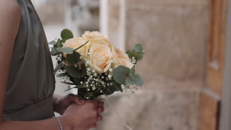 bridesmade is holding the bouquet.