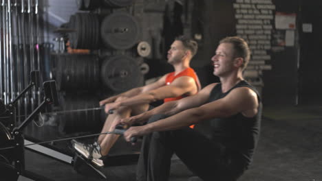 men working out on rowing machines in a gym