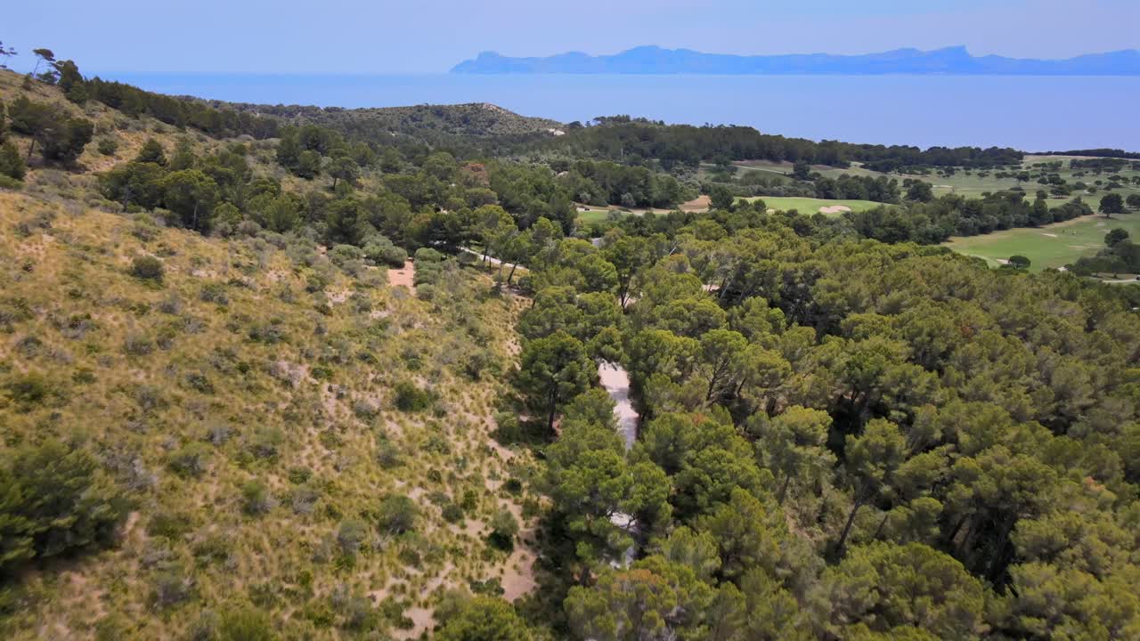 Beautiful greenery surrounds winding paths leading to serene coastal views in Mallorca. This area showcases the natural beauty of Coll Baix and the tranquil vibes of Mal Pas.
